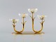 Gunnar Ander for Ystad Metall. Candlestick in brass and clear art glass shaped 
like flowers. 1950s.
