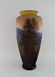 Émile Gallé (1846-1904), France. Very large and rare "Vosges" vase in mouth 
blown cameo art glass. Mountain landscape with trees in relief. Approx. 1900.
