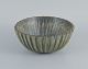 Arne Bang. Large stoneware table bowl with fluted body decorated with green 
mottled glaze.