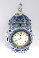 Royal Copenhagen. Blue Fluted, Full lace. Table clock with Zenith movement. 
Model 1017. Height 29 cm. There is a small chip on one foot (see photo). (1 
quality). Produced before 1923.