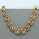 Antik 
Damgaard-
Lauritsen 
presents: 
A. F. 
Rasmussen; A 
wide necklace 
of 14k gold, l. 
42 cm.