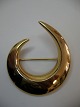 Broche i 14 karat guld fremstillet af Hans Hansen i tresserne. Længde ca, 4,9 cm og breddde ca. ...