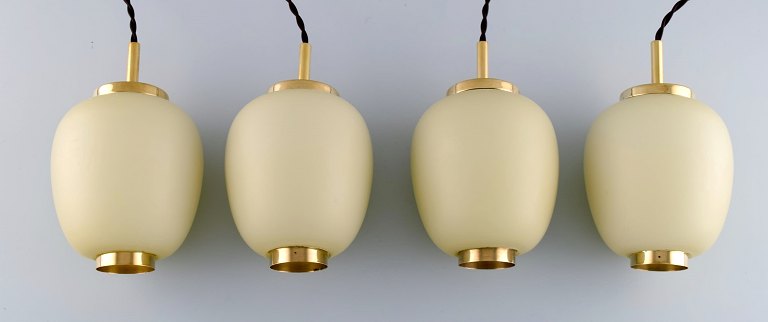 Danish design. Four China lamps / pendants made of matt opal glass with brass 
mounting. 1960s.
