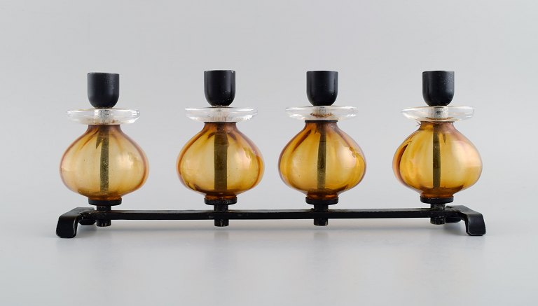 Erik Höglund for Kosta Boda. Candlestick in cast iron and mouth blown art glass. 
1960s / 70s.
