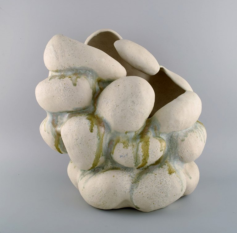 Christina Muff, Danish contemporary ceramicist (b. 1971). Hand modeled 
sculptural vase of stoneware clay. The vessel is glazed with warm white glaze 
mixed with minerals from Danish beaches and has ashglaze runs in blue and green. 
Part of the 