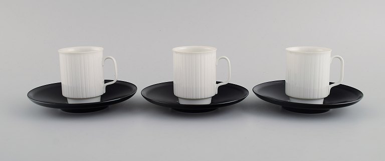 Tapio Wirkkala for Rosenthal. Three porcelain noire mocha cups with saucers in 
black and white fluted porcelain. 1980