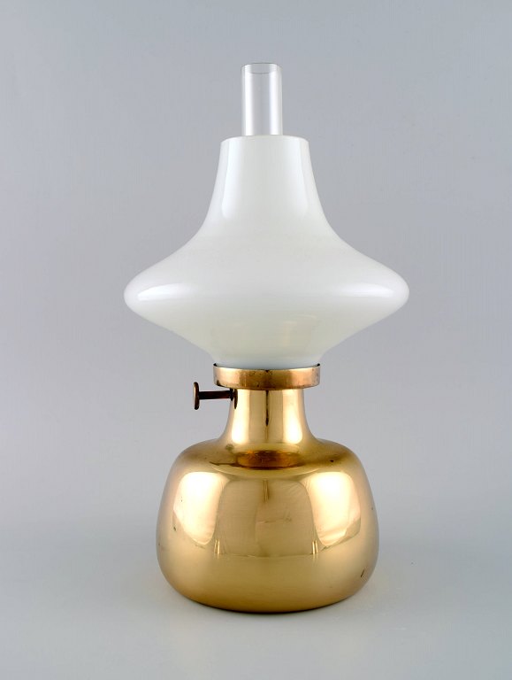 Henning Koppel (1918-81) for Louis Poulsen. "Petronella" oil lamp in brass with 
opaline glass shade.
