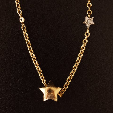 Ole Lynggaard; necklace in 14k gold with star shaped lock and a star shaped 
pendant with two diamants