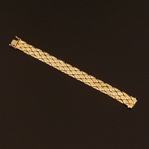 Leddelt 18kt guld armlænke med rhombeformede led. 
L: 19,5cm. V: 33,5gr