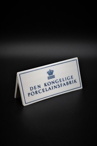 Old dealer sign in porcelain from Royal Copenhagen "Den Kongelige 
Porcelænsfabrik" H:6cm. L:14cm.