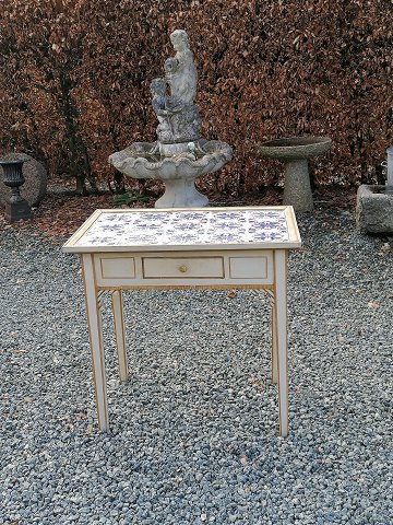 Tile table with 15 softly decorated tiles on 
tendon frames