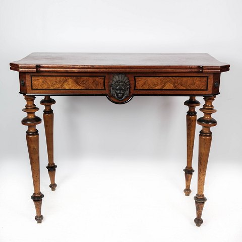 Antique game table with extention, of mahogany and walnut decorated with 
carvings from the 1860s.
5000m2 showroom.