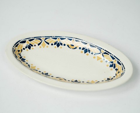 Oval dish decorated with blue and yellow colours from the 1960s. 
5000m2 showroom.