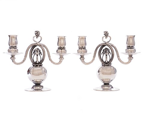 Pair of early Georg Jensen sterlingsilver 
candelabra 324. Designed 1919. H: 22cm. W: 25cm. 
W: 2.085gr