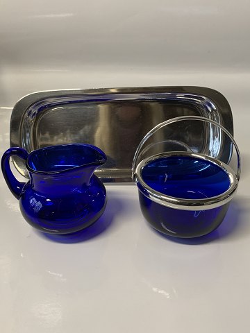 Sugar bowl and cream jug in blue glass and silver stain. Stamped M&TB