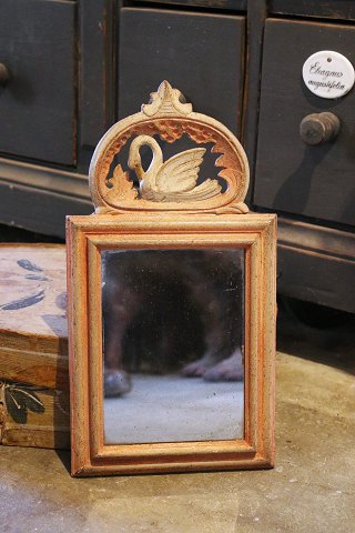 Swedish 19th century, small mirror in wood with a fine carved swan on top...