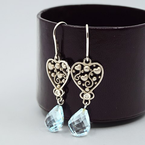 Ole Lynggaard; earrings of 18k white gold set with topaz and diamond