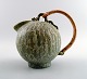 Arne Bang pottery pitcher with wicker handle.
