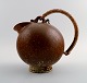 Arne Bang art pottery pitcher with wicker handle.
Marked AB. 151.
