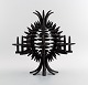 Jens H. Quistgaard: b. Copenhagen 1919, d. 2008.
A circular, pineapple shaped candlestick of patinated iron. Eight candle 
holders/spears.