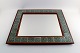 Jens H. Quistgaard: b. Copenhagen 1919, d. 2008.  
Wall mirror with Pao Rosa frame, inserted with patterned green stoneware tiles.