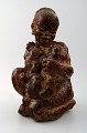 Royal Copenhagen Stoneware Figure of black boy with cat # 20244.
Designed by Knud Kyhn.