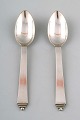 Two Georg Jensen Pyramid grapefruit spoons.
