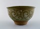 Unique Erik Reiff for Royal Copenhagen. Stoneware bowl, decorated with bright 
spiral pattern on green background.