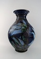Kähler, Denmark, glazed stoneware floor vase decorated with flowers in blue 
shades.
