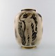 Gunnar Nylund for ALP Lidköping. Unique hand crafted Art Deco Flambé vase in 
ceramic with nude woman carrying jar. 1930