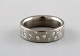 Modernist ring in titanium with numerous diamonds.