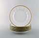 Royal Copenhagen. Six dinner plates in porcelain with gold border.
