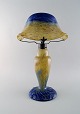 Daum Nancy, France. Large art deco "Verre de jade" table lamp in blue and green 
mouth blown art glass with leaf-shaped screen holder. Dated 1919-23.
