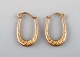 Scandinavian jeweler. A pair of 8 carat gold earrings in the form of horseshoes. 
Mid 20th century.
