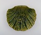 Clam shaped Höganäs art nouveau dish in glazed ceramics. Beautiful autumn glaze 
in green shades. Early 20th century.
