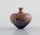 Isak Isaksson, Swedish ceramist. Unique vase in glazed ceramics. Beautiful glaze 
in brown and blue shades. Dated 1988.
