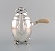Early Georg Jensen Magnolia coffee pot in sterling silver with handle in ivory. 
Model number 2D. 1920