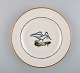 Royal Copenhagen lunch plate in hand-painted porcelain with bird motifs and gold 
decoration. Early 20th century. Four pieces in stock.
