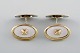 Scandinavian silversmith. A pair of gilded art deco cufflinks in silver (835) 
and mother of pearl. Mid-20th century.
