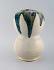 European studio ceramist. Large unique vase in glazed ceramics. Beautiful green 
blue glaze on a cream background. 1980