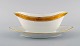 Royal Copenhagen stel nr. 607, White. Porcelain sauce boat with gold edge. Model 
number 607/9344.
