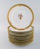 12 Royal Copenhagen "Golden Basket" dinner plates with gold edge. Model number 
9586. Mid 20th century.

