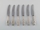 Seks sjældne og antikke Georg Jensen Klokke frokostknive i sterlingsølv og 
rustfrit stål. 1910