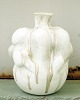 Christina Muff, Danish contemporary ceramicist (b. 1971). Large hand modeled 
sculptural vase with a bottleneck opening, made in soft white stoneware clay. 
The vessel is covered in cream white glaze and has glazedrips in golden and grey 
notes.