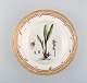 Royal Copenhagen flora danica deep plate in porcelain with hand-painted flowers 
and gold decoration. Early 20th century.
