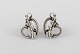 A pair of Georg Jensen ear screws in sterling silver. Hearts with foliage. 
Design number 115.
