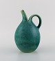 Eva Stæhr-Nielsen for Saxbo. Pitcher in glazed stoneware. Beautiful glaze in 
shades of green. 1940s.