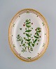 Royal Copenhagen Flora Danica oval serving bowl in hand-painted porcelain with 
flowers and gold decoration. Model number 20/3506.
