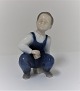 Bing & Grondahl. Porcelain figure. Sitting boy. Model 2402. Height 12 cm. (1 
quality)