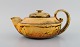 Kähler, Denmark. Teapot in glazed stoneware. Beautiful yellow uranium glaze. 
Mid-20th century.
